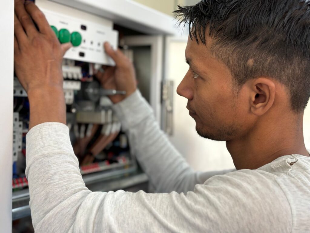 Skilled electrician working on an electrical panel