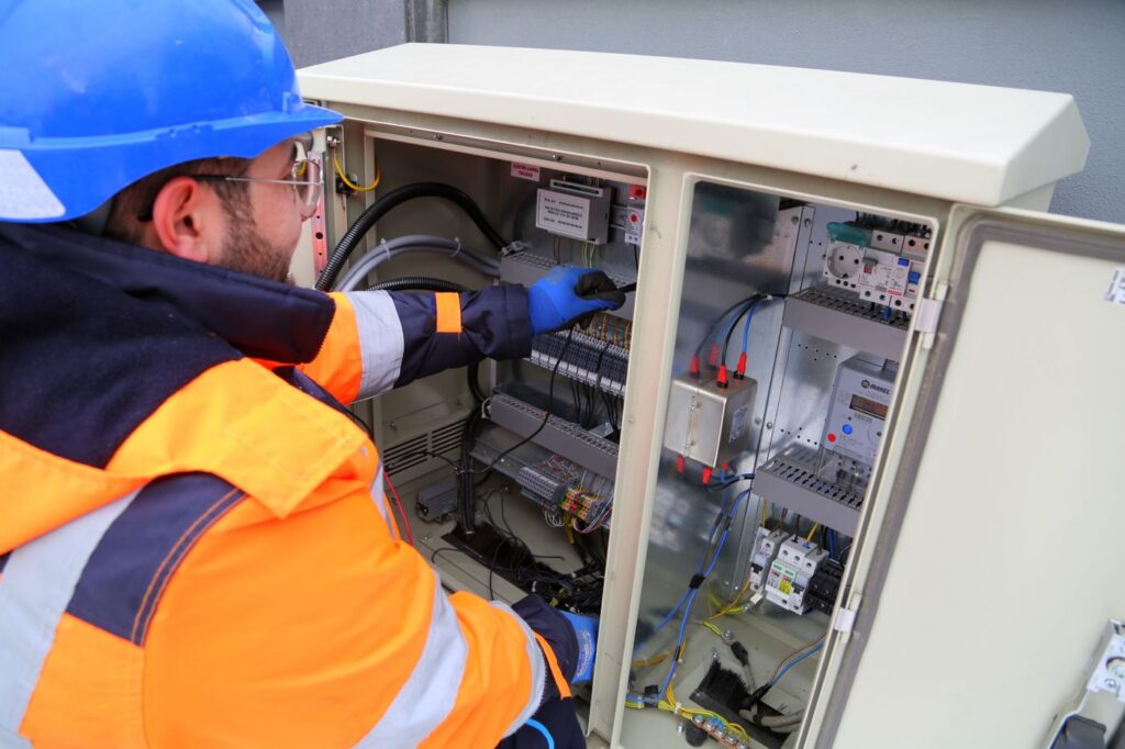 Electrician checking a fuse box on site