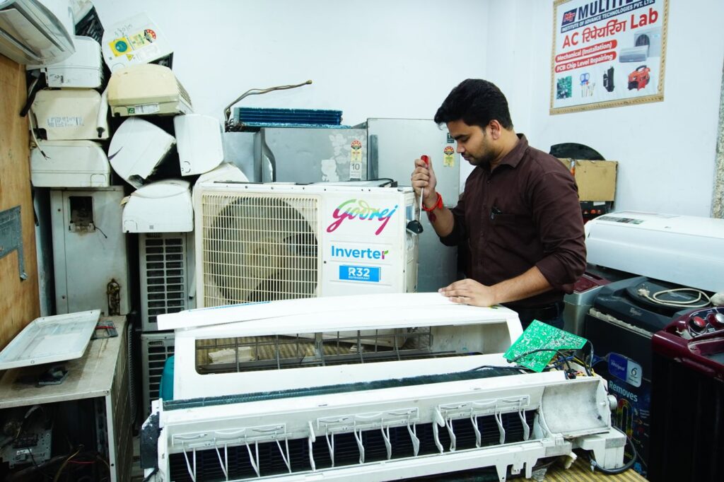 HVAC technician servicing an AC unit in Riyadh