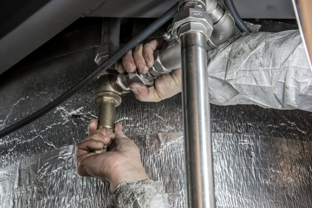 Plumber installing pipes on a construction site in Dubai